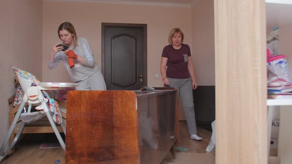 Woman Taking Picture Of Furniture