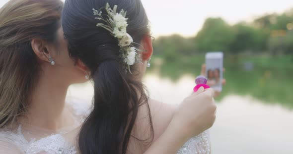 Happy Asian Lesbian Married Couple Take A Photo Selfies Together By Smartphone.