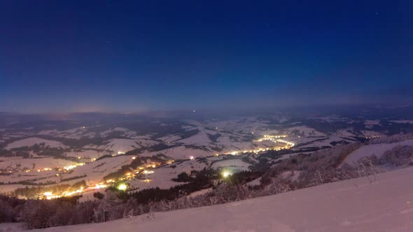 Time Lapse Video with Blue Sky Fog and Snow of a Starry Sky Over Snowy Ski Resort in the Mountains