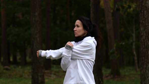 Happy Young Woman Stretching Arms Outdoors