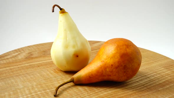 Movement of Pears on the Wooden Board on White Background