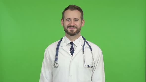 Cheerful Doctor Smiling at Camera Against Chroma Key