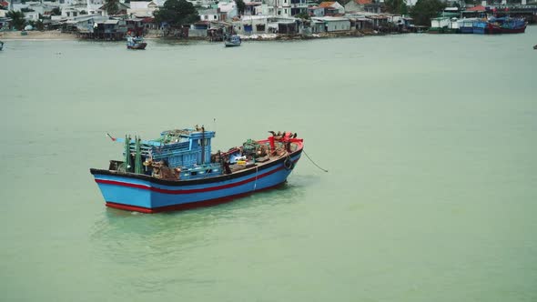 Fishing Boat At Anchor Off Poor Village In Nha Trang
