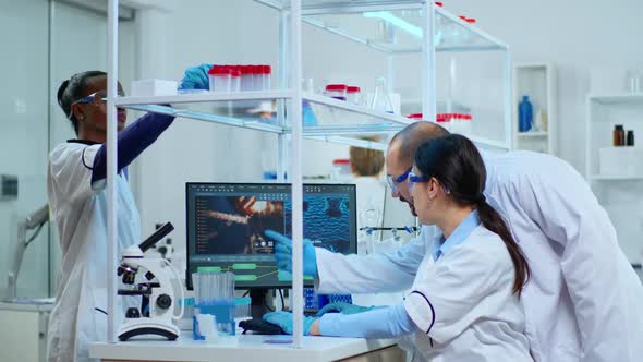 Team of Microbiology Scientists Discussing About Virus Development alt