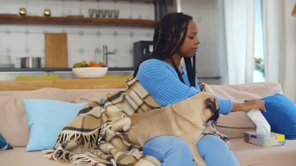 Sick African Woman with Flu Infection at Home with Dog