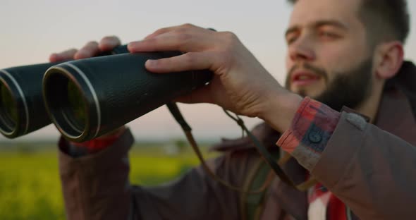 The Guy Is Looking Through Binoculars