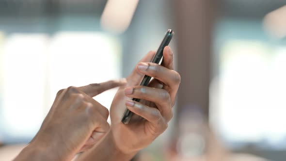 Hands of African Man Using Smartphone