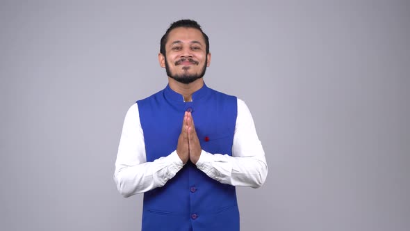 Indian man greeting everybody in an Indian outfit