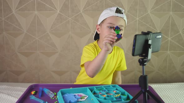 A Cool Boy in a Baseball Cap Makes a Video for His Blog