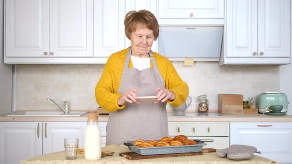 Grandmother and Granddaughter Cooking Tomato Soup in the Kitchen