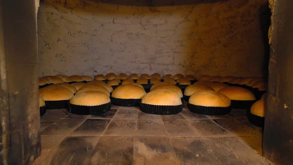 Rustic old retro oven that has lot of bread in it.