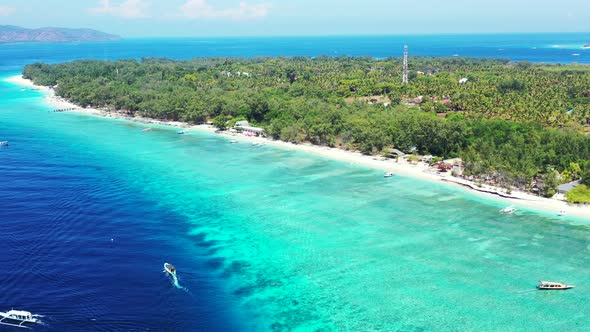 Tropical above tourism shot of a sunshine white sandy paradise beach and turquoise sea background in