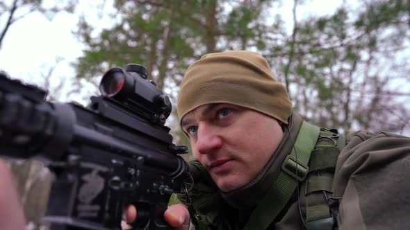 Closeup Concentrated Cautious Soldier Aiming with Gun Looking Away Talking in Earphone in Slow