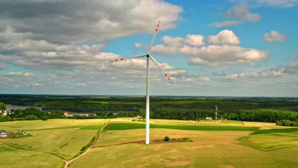 Wind turbines on green field with blue sky, view from above, Poland