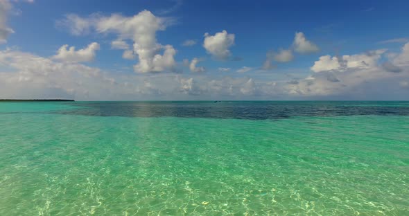 Wide angle aerial tourism shot of a white paradise beach and turquoise sea background in hi res 4K