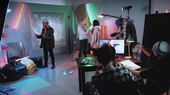 Mixed Race Stars and Crew Preparing for the Scene in Modern Film Studio