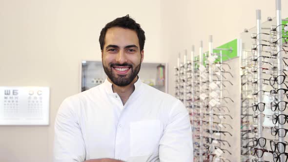 Optician Doctor Near Showcase With Eyeglasses At Glasses Shop