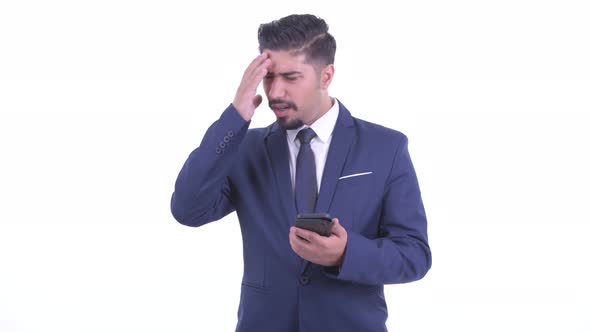 Stressed Bearded Persian Businessman Using Phone and Getting Bad News