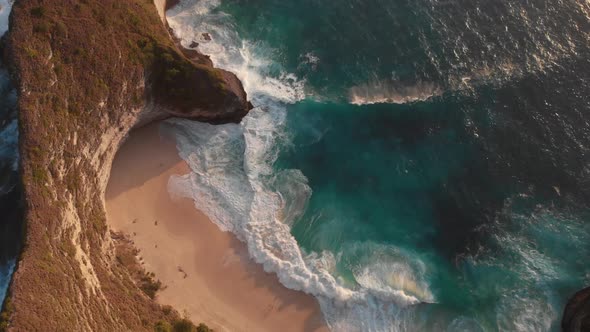 Aerial drone view of Nusa Penida Kelingking Beach during sunset.  Bird eye view.