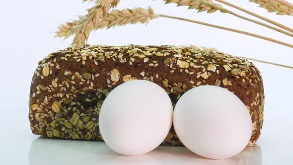 Close Up Rotation Bread Still Life On A White Background, Spikelets Of Wheat With Bread