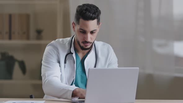 Serious Concentrated Man Doctor Physician Wear White Coat Using Computer Internet Typing Appointment