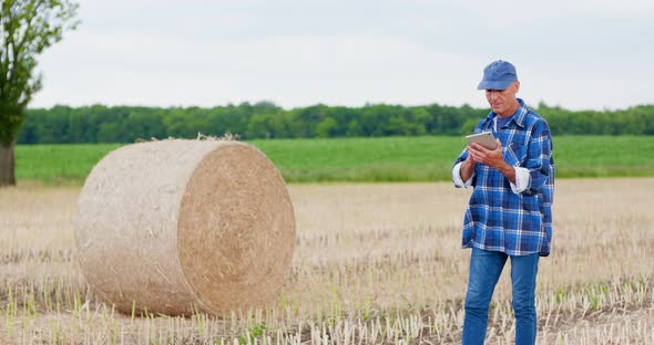 Agriculture Farmer Working on Field on Digital Tablet Computer