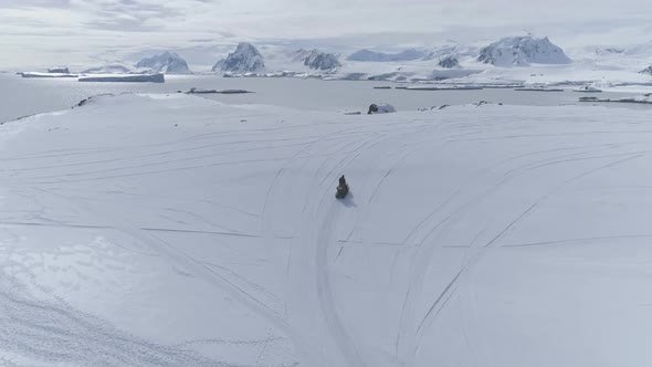Aerial Flight Over Moving Snowmobile. Antarctica