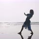 Silhouette of young woman dancing with gymnastic elements at the sandy beach - VideoHive Item for Sale