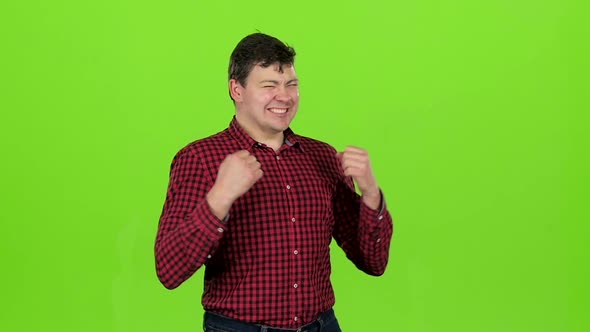 Young Guy Is Happy with His Victories, He Is Happy. Green Screen. Slow Motion