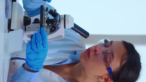 Vertical Video Woman Scientist Making Research Using Microscope