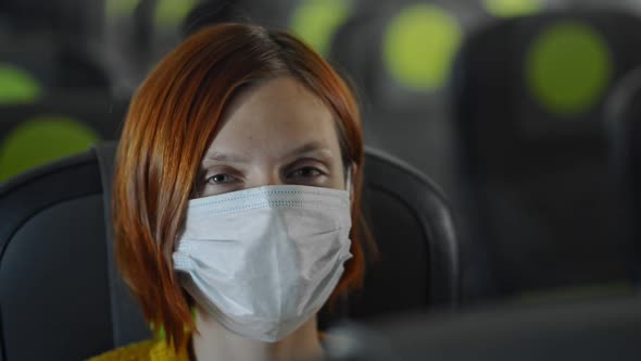 Happy Lady in Mask in Airplane Travelling During Quarantine Avki