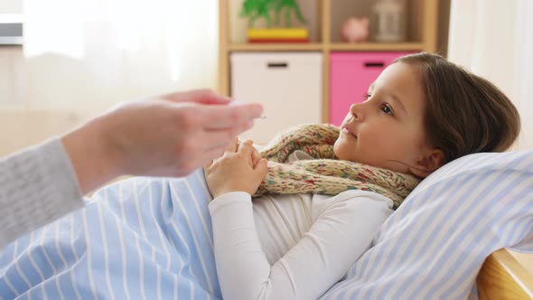 Mother Measuring Temperature of Sick Daughter