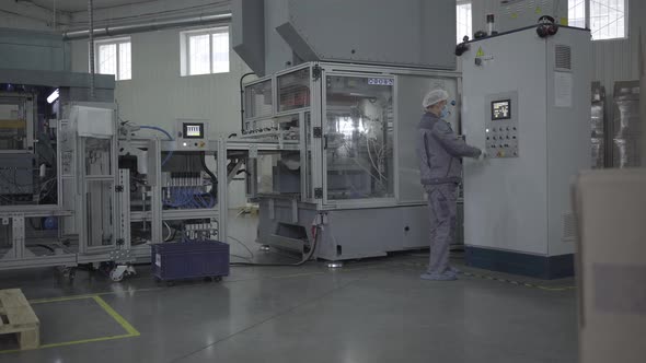 Extreme Wide Shot of Man Working on Production Site with Industrial Equipment. Portrait of Confident