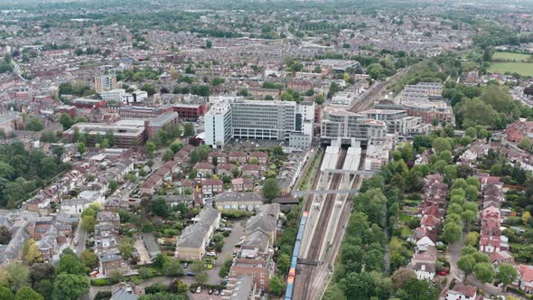 Drone shot over South Western British Rail train arriving at Twickenham station