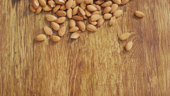 Video of almonds on wooden background