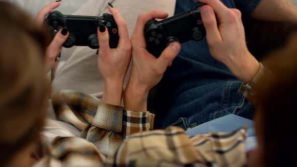 Couple Hands Using Joysticks at Home Closeup