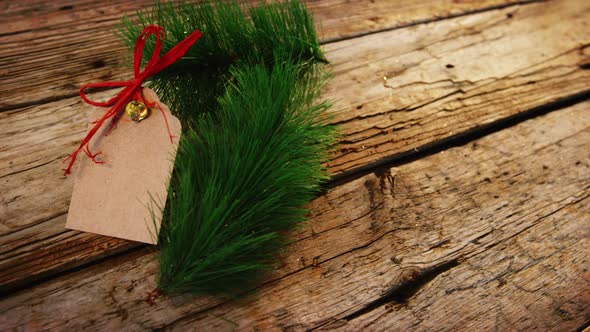 Christmas fir and tag on wooden plank