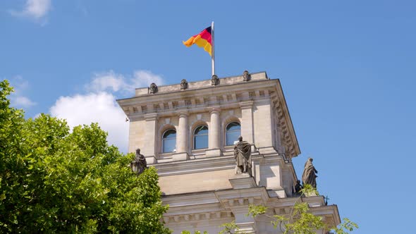 Detail of Reichstag Building in Berlin and Waving German National Flag