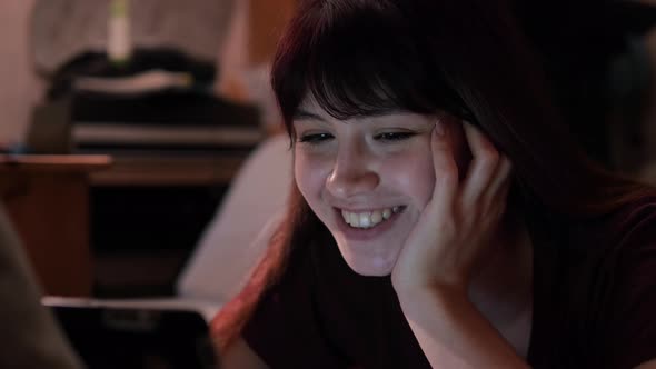 Happy Young Caucasian Woman Communicates By Video Call With Her Family Friends