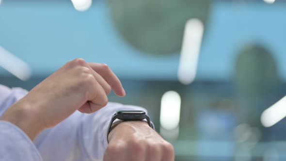 Close Up of Young Man Using Smart Watch