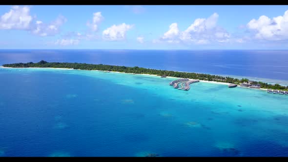 Aerial drone shot nature of beautiful resort beach voyage by blue green ocean and white sand backgro