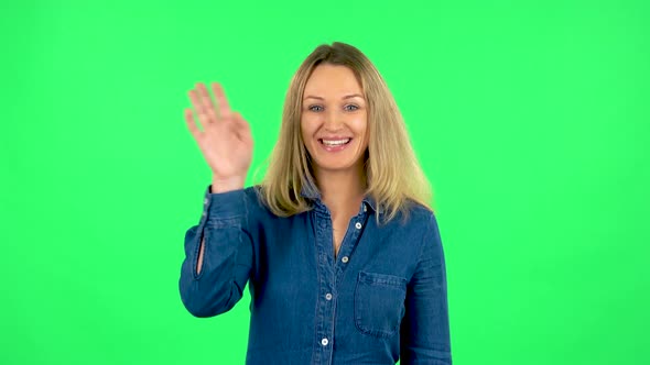 Portrait of Fair Woman Is Waving Hand and Showing Gesture Come Here. Green Screen