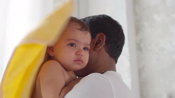 Father Drying Toddler Girl after Bath