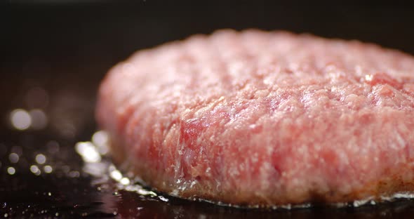 Raw Burger Meat Is Fried in a Frying Pan. 