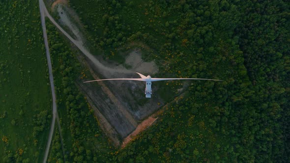 Top View of Huge Windmill Working on Green Field