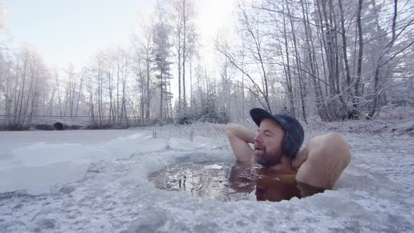 The ice bather puts his arms behind his head and relaxes into the session