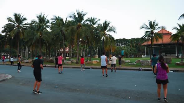 Back View of Dancing Peoples on Group Training in Public City Park