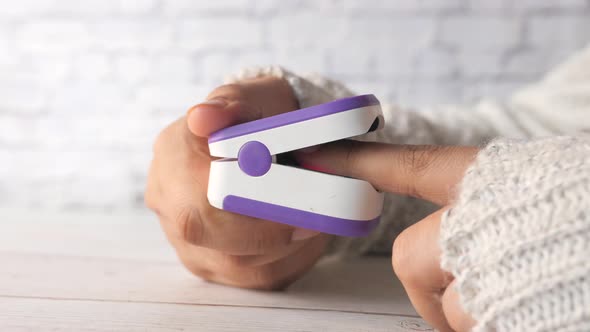 Young Women Hand Using Pulse Oximeter