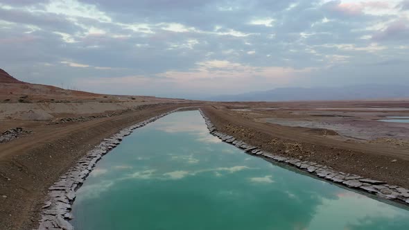 Israel, Turkiz color channel of water by the Deadsea, Drone shot fly over