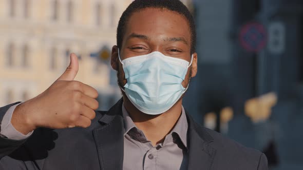 Mixed Race Businessman in Suit Wears Medical Face Mask